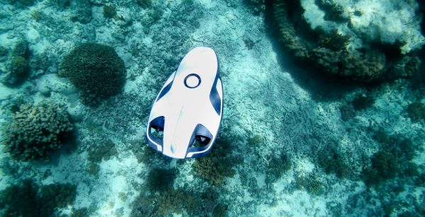White robotic underwater drone pictured exploring the sea floor