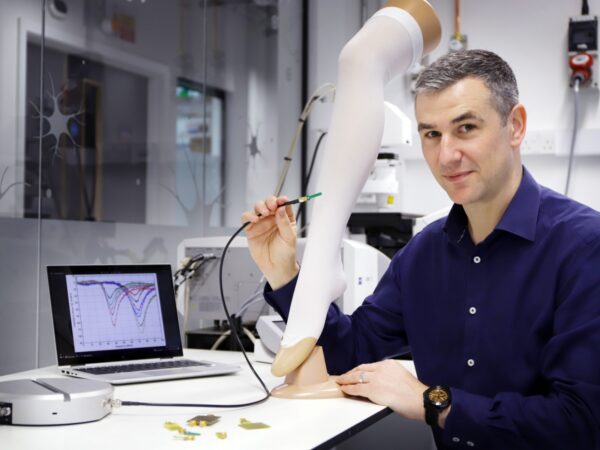 Dr Philip Hands holds the reader to measure the stockings pressure